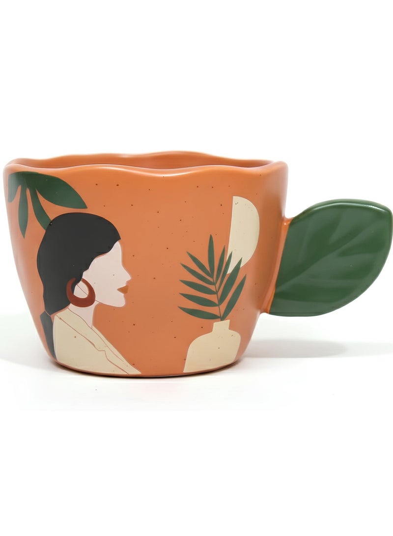 مج بورسيلين راقي سعة 360 ملي باللون البرتقالي التراكوتا مع مقبض مبتكر على شكل ورقة شجر خضراء وتصميم فني لوجه امرأة ونباتات استوائية - Image 1